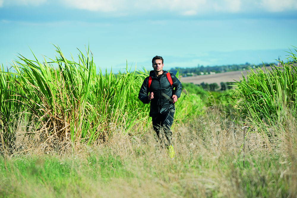 trail runner running in the grass